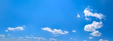 Clear blue sky panoramic background with small white clouds. The varying altitudes of the solitary...