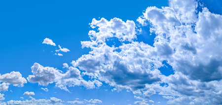 A raster image of a cloud photographed against a blue sky. Easy relaxed cottony shape. Background quiet sky. Contours after rain. Lonely substance water. Form of freedom.の写真素材