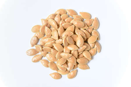 Pumpkin seeds on white background. close up top viewの写真素材