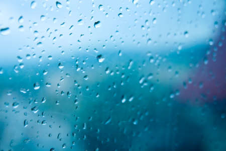 Rain on the window of the car - close up of water. Droplets of water on the window. Water on the window of car.の写真素材