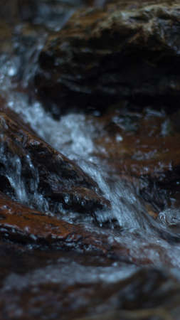Close up of mountain river flows between picturesque summer stones. Rocks in the mountains with water flowingの写真素材