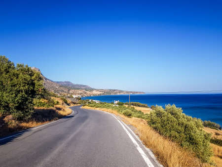Coastline and a curving road in Keratokampos, Creteの写真素材