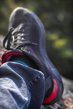 A Close up of jeans and sneakers in natureの写真素材