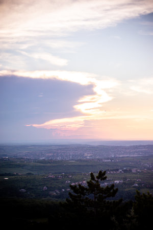 Cloudy sky and lanscape of mountain and city during the sunsetの写真素材