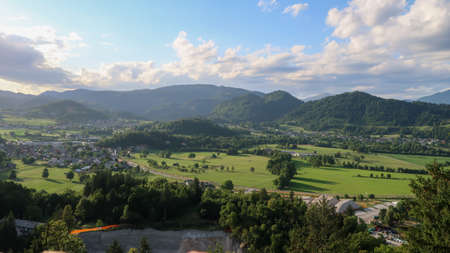 Panoramic view to the town Bled and surrounding mountains through a windowの写真素材