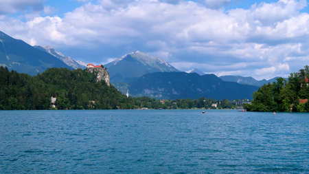 View of lake Bled in Slovenia and surrounding mountains during a sunny day. Bled Castle in the distanceの写真素材