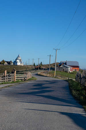 Curving asphalted road in the mountains in Lupcina, Romaniaの写真素材