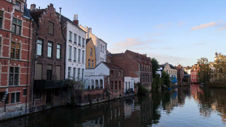 Gent, Belgium, 8th of November 2021 - River channels and buildings during sunsetのeditorial素材