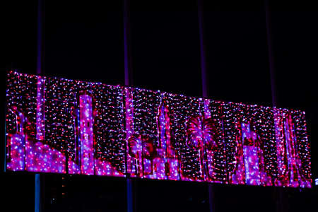 New Year lights with palm trees and clock tower during the night in Izmir, Turkeyの写真素材
