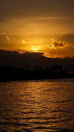 Sunset over the mountains and the coast - bay of Aegean Sea in Izmir, Turkey with copy space