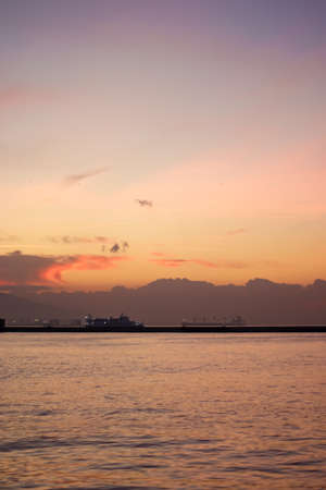 Sunset over the mountains and the coast - bay of Aegean Sea in Izmir, Turkey with copy spaceの写真素材