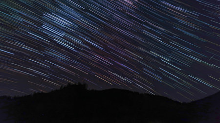 Mountain landscape during the night with colourful stars trails and clear sky. Stars at nightの写真素材