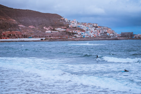 Surfer riding a board on the waves of the oceanの写真素材