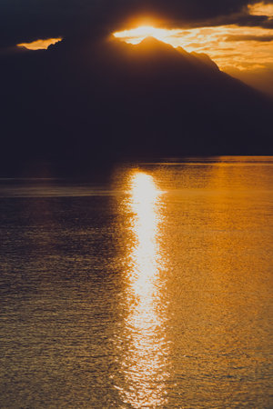 Sun reflecting in the sea. Landscape of the Mediterranean sea with mountains in the distance during the sunset, Antalya, Turkeyの写真素材