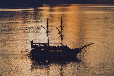 Landscape of boat - yacht in the Mediterranean sea with orange color during sunset in Antalya, Turkeyの写真素材