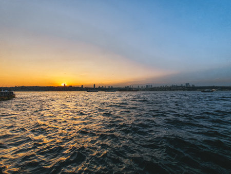 View of Bosphorus and Istanbul city during the sunset with the sun reflecting in the waterの写真素材