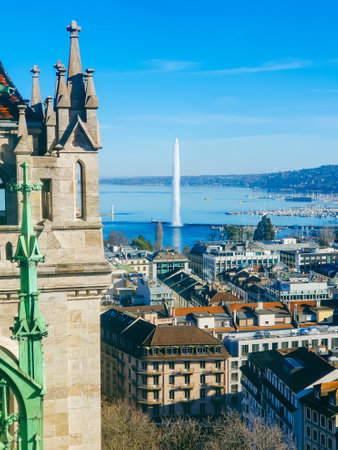 A breathtaking view of Genevaâs rooftops, Lake Geneva, and the Alps, framed by the gothic architecture of St. Pierre Cathedralの写真素材