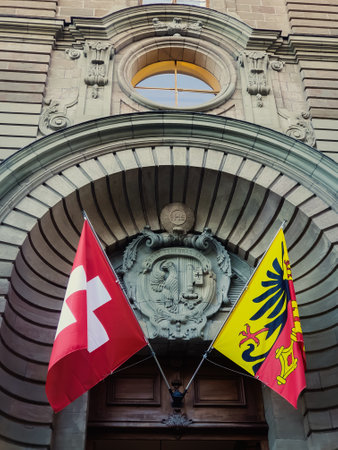 The Palais de Justice in Geneva, Switzerland, showcasing its historic architecture with Swiss and Geneva flags at the entranceの写真素材