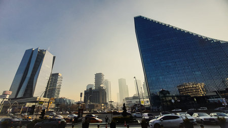 19th of December 2024, Ankara, Turkiye - Modern glass skyscrapers and urban traffic under a clear...