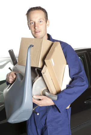 Mechanic looking at camera in studio with carの写真素材