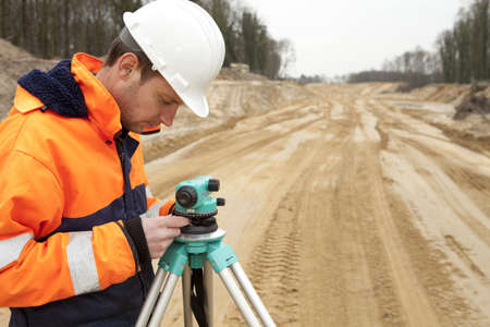 Land surveyor working on a construction site.