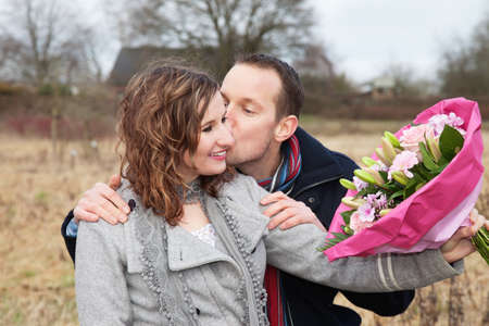 Lovers Kissing With Bouquetの写真素材