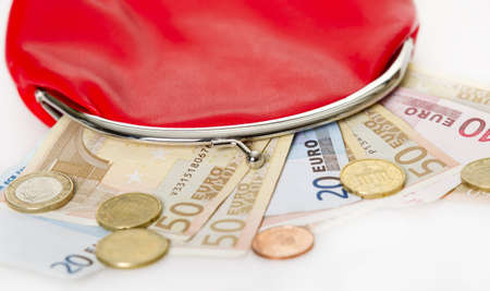 Red purse with euro paper money and change isolated on white backgroundの写真素材