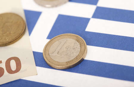 Closeup of one euro coin on Greek flagの写真素材