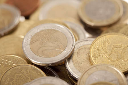 Closeup of shiny euro cents piled up on each otherの写真素材