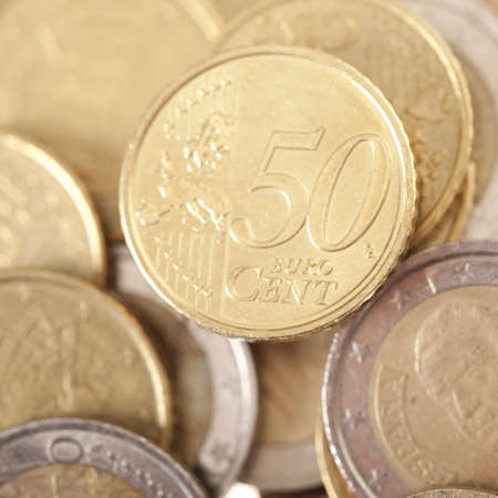 Closeup of fifty gold euro currency with other centsの写真素材