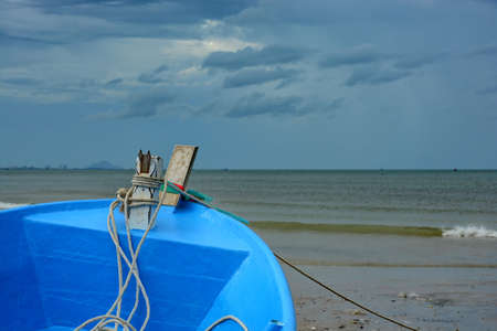 The boat facing the sea and gray sky. の写真素材