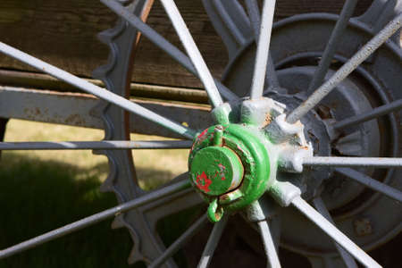 An Old Antique Spoked Wagon Wheel with chipping paint.の写真素材