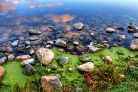 HDR of a rocky bank on a river.の写真素材