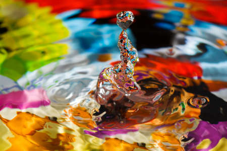 Close ups of water drop sculptures on a colorful background.の写真素材