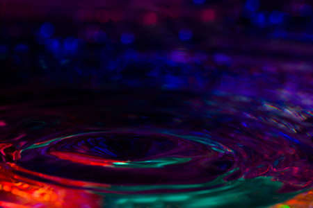 A drop of water created a rippling wave.の写真素材