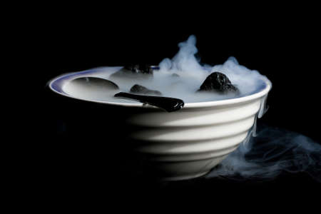 A Smoking bowl of lava rocks and spoon.の写真素材