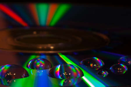 Abstract music background, colorful water drops on CD/DVD disc の写真素材