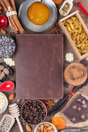 Cover of the book to write prescriptions surrounded ingredients for a sweet holiday bakingの写真素材