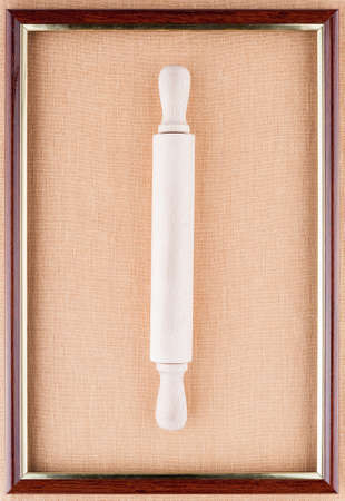 Rolling-pin in the center of the frame on a linen backgroundの写真素材
