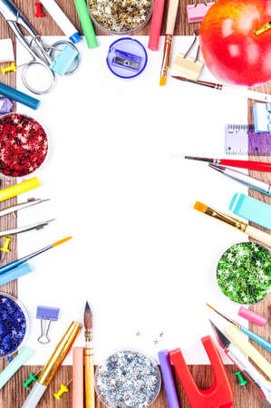 White sheet of paper, surrounded by tools for drawing and big red appleの写真素材