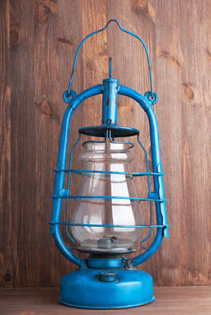 Old kerosene lantern on the dark wooden backgroundの写真素材