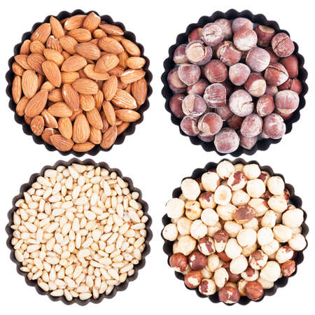 Assorted nuts in a bowl with wavy edges, isolated on whiteの写真素材