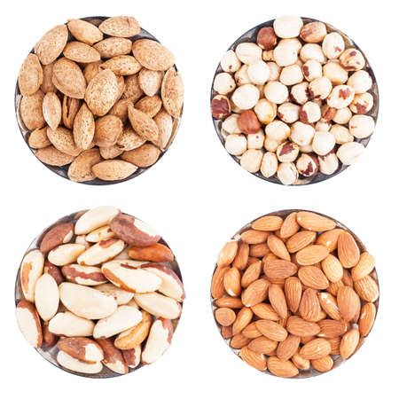 Assorted nuts on a flat plate, isolated on whiteの写真素材