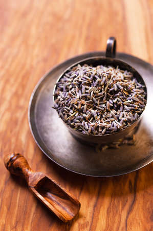 Dried lavender flowers on olive wooden backgroundの写真素材