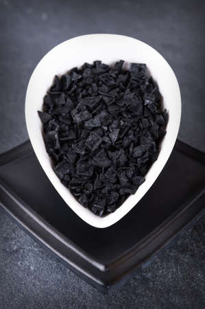 Black salt flakes of cyprus in the bowlの写真素材