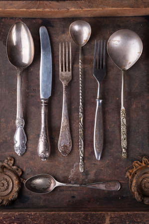 Old cutlery in an old wooden boxの写真素材