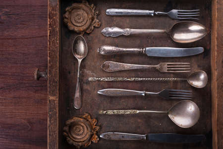 Old cutlery in an old wooden boxの写真素材