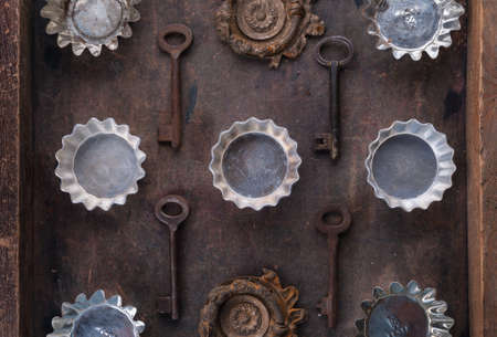 Antique forms for cookies and old keys on the wooden backgroundの写真素材