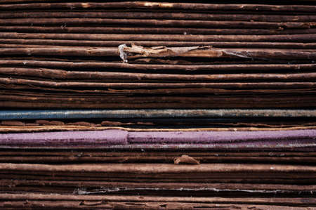 The ends of the stack of old cardboard backgroundの写真素材