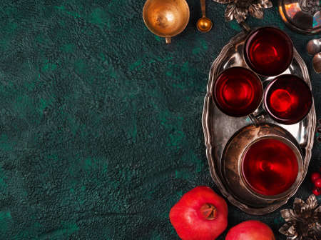 Pomegranates and pomegranate juice on textural background top view with copy spaceの写真素材